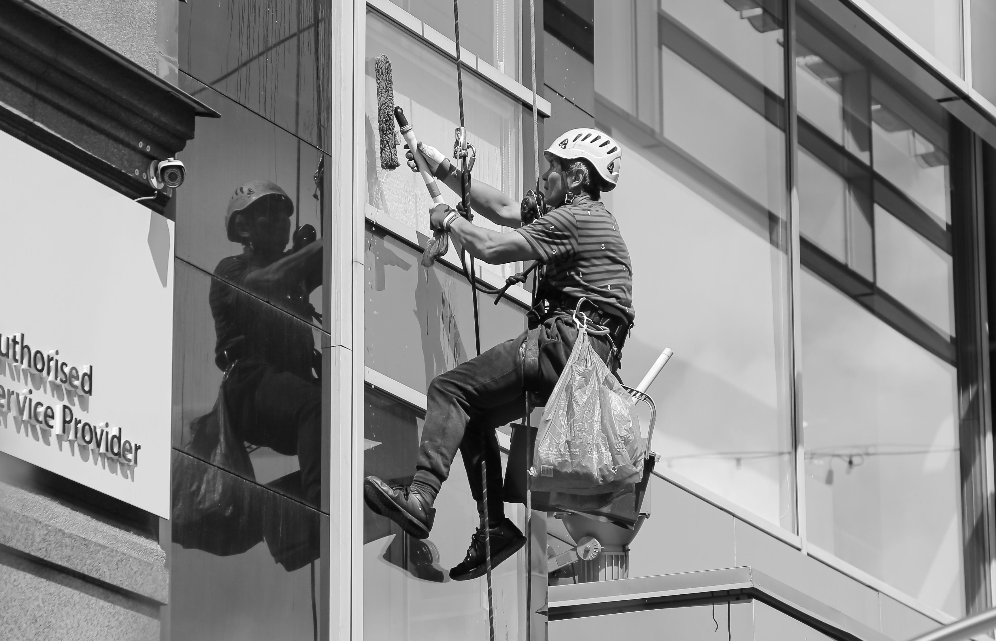 Phoenix Exterior Cleaning washing a house window with a water-fed pole